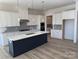 Modern kitchen with white cabinets, quartz countertops, and a large island at 5217 Glenwalk Dr # 0059, Charlotte, NC 28269