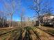 Ranch home with backyard, trees, and leaf-covered lawn at 187 Newland Ln, Statesville, NC 28625