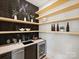 Modern butler's pantry with herringbone tile,floating shelves, and wine storage at 934 Laurel Creek Ln, Charlotte, NC 28211