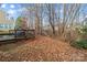 Backyard with wooden deck and wooded area beyond at 105 Collenton Ln, Mooresville, NC 28115