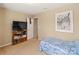 Cozy bedroom with a twin bed, TV, and storage shelving at 105 Collenton Ln, Mooresville, NC 28115