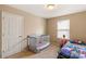 bedroom with crib, twin bed, and window at 105 Collenton Ln, Mooresville, NC 28115