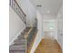 Stairwell with wood railing and carpet runner, leading to an open living area at 224 Winford Dr, Troutman, NC 28116