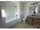 Modern bathroom with a soaking tub, white tile, and updated fixtures at 926 Laurel Creek Ln, Charlotte, NC 28211