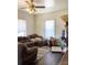 Living room with brown sectional sofa, rug, and window coverings at 142 3Rd Ave, China Grove, NC 28023