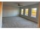 Spacious bedroom with neutral walls and carpet flooring, three windows at 121 High Rock Ct # 08, Statesville, NC 28677