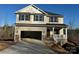 Two-story house with beige vinyl siding, stone accents, and a two-car garage at 121 High Rock Ct # 08, Statesville, NC 28677