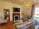 Spacious living area featuring hardwood floors, a fireplace, and kitchen view at 902 N Ashe Ave, Newton, NC 28658