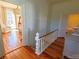 View of staircase with hardwood floors and white railing at 902 N Ashe Ave, Newton, NC 28658