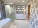 Elegant bathroom with soaking tub, glass shower, and built-in shelving at 902 N Ashe Ave, Newton, NC 28658