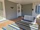 Inviting front porch with a porch swing and terracotta tile floor at 902 N Ashe Ave, Newton, NC 28658