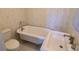 Charming bathroom featuring a clawfoot tub, pedestal sink, and patterned wallpaper at 902 N Ashe Ave, Newton, NC 28658