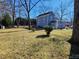 Large backyard with grass, trees, and a shed at 902 N Ashe Ave, Newton, NC 28658
