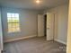 Bright bedroom with a large window and gray carpeting at 125 High Rock Ct # 07, Statesville, NC 28677