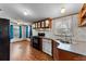 Kitchen with wood cabinets, laminate flooring, and a double sink at 3430 Potneck Rd, Salisbury, NC 28147