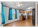 Bright kitchen with teal curtains, wood cabinets and laminate floors at 3430 Potneck Rd, Salisbury, NC 28147
