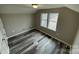 Well-lit bedroom with grey vinyl flooring and two windows at 108 Lee Dr, Shelby, NC 28150
