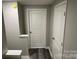 Grey hallway with wood-look flooring and two doors at 108 Lee Dr, Shelby, NC 28150