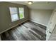 Simple bedroom with grey walls, wood-look flooring, and two windows at 108 Lee Dr, Shelby, NC 28150