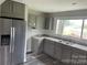 Modern kitchen with gray cabinets, stainless steel appliances, and granite countertops at 108 Lee Dr, Shelby, NC 28150