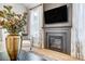 Modern fireplace with dark gray mantel and neutral wall decor at 4819 Wolf Pond Rd, Monroe, NC 28112