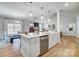 Spacious kitchen with island, stainless steel appliances, and hardwood floors at 4819 Wolf Pond Rd, Monroe, NC 28112