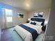 Bedroom with navy blue bed and hardwood floors at 169 Salem Springs Ln, Statesville, NC 28625