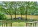 Steps down to a wooden dock with a small boat on a lake at 4115 Cascade St, Terrell, NC 28682