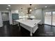 Modern kitchen with large island, stainless steel appliances, and hardwood floors at 533 Amon Ln, Pineville, NC 28134