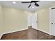 Light-filled bedroom with hardwood floors and door to hallway at 533 Amon Ln, Pineville, NC 28134