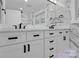 Double vanity bathroom with marble and white cabinets at 533 Amon Ln, Pineville, NC 28134