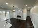 Bright dining area with a marble fireplace and dark hardwood floors at 533 Amon Ln, Pineville, NC 28134