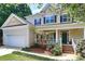 Two-story house with beige siding, shutters, and porch at 1423 Piper Ct, Concord, NC 28025