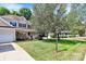 Two-story house with beige siding, a white garage door, and a well-maintained lawn at 1423 Piper Ct, Concord, NC 28025