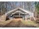 Detached garage with carport covering and ample storage space at 1095 Mount Ulla Hwy, Mooresville, NC 28115