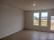 Living room with large windows, wood-look flooring, and access to a deck at 4225 S New Hope Rd # 9, Cramerton, NC 28032