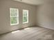 Bright bedroom with neutral carpeting and large windows at 4223 S New Hope Rd # 8, Cramerton, NC 28032