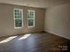 Bright bedroom with hardwood floors and two windows at 4229 S New Hope Rd # 11, Cramerton, NC 28032