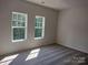 Bright bedroom with neutral walls and carpet, featuring two large windows at 4229 S New Hope Rd # 11, Cramerton, NC 28032