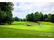 Putting green with scenic background and player at 4227 S New Hope Rd # 10, Cramerton, NC 28032