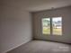 Bright bedroom with neutral walls, carpeted floors and a window at 4227 S New Hope Rd # 10, Cramerton, NC 28032