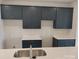 Modern kitchen with dark blue cabinets and white counters at 4227 S New Hope Rd # 10, Cramerton, NC 28032