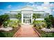 Stunning glass conservatory with brick pathway and lush landscaping at 4227 S New Hope Rd # 10, Cramerton, NC 28032