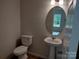 Clean bathroom with pedestal sink and oval mirror at 4227 S New Hope Rd # 10, Cramerton, NC 28032