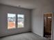 Primary bedroom with large windows and ensuite bathroom access at 4227 S New Hope Rd # 10, Cramerton, NC 28032