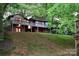 Two-story house with wrap-around deck and beautiful landscaping at 165 Clearview Point Dr, Mount Gilead, NC 27306