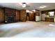 Open concept living room with brick fireplace and view into kitchen area at 165 Clearview Point Dr, Mount Gilead, NC 27306