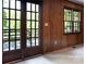 Spacious living room with wood paneling, fireplace, and access to deck at 165 Clearview Point Dr, Mount Gilead, NC 27306