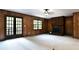 Living room features wood paneling, brick fireplace, and carpeted floor at 165 Clearview Point Dr, Mount Gilead, NC 27306
