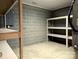 Unfinished basement with ample storage shelving and concrete floor at 165 Clearview Point Dr, Mount Gilead, NC 27306